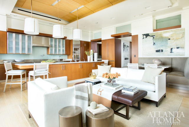 A trio of pendants by Palmer Hargrave through Ainsworth- Noah and new barstools by Gregorius Pineo through Jerry Pair freshen up the open kitchen. The abstract painting is by Jeane Myers through Pryor Fine Art.