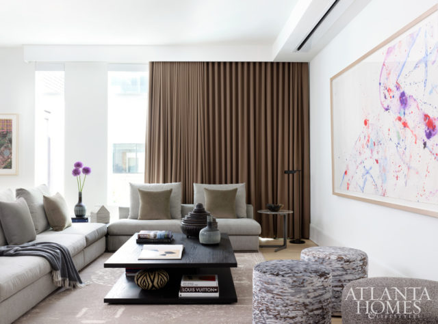 A recessed projector screen allows an abstract painting by Sam Francis to inject the media room with color and movement when the TV is not in use.