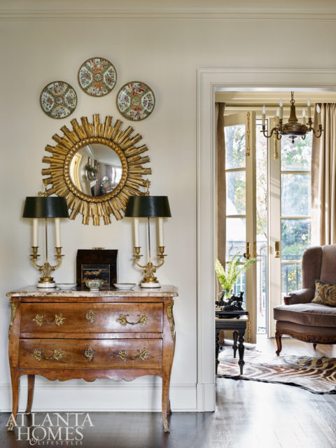 A grouping of famille rose porcelain mixes with other prized antiques in a corner of the living room.