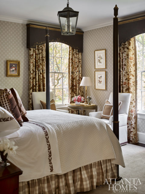For the guest bedroom, Bryan reused curtains that once hung in the family room and commissioned cornices with gilded detailing to match the newly painted poster bed.