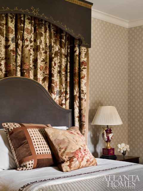 For the guest bedroom, Bryan reused curtains that once hung in the family room and commissioned cornices with gilded detailing to match the newly painted poster bed.