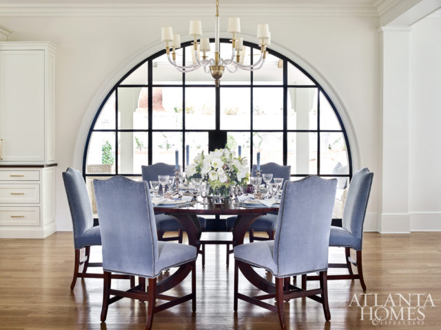 Bosbyshell helped her client style the table for the holidays, incorporating treasured dishware, antique silver and napkins and place mats from Gramercy Fine Linens & Furnishings. The walnut table is from Hickory White and the upholstered chairs from Hickory Chair.