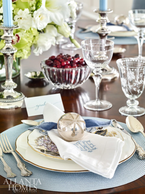 Bosbyshell helped her client style the table for the holidays, incorporating treasured dishware, antique silver and napkins and place mats from Gramercy Fine Linens & Furnishings. The walnut table is from Hickory White and the upholstered chairs from Hickory Chair.