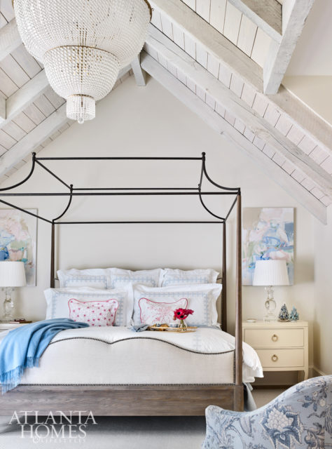Vaulted ceilings dressed in whitewashed wood planks add drama to the master bedroom.