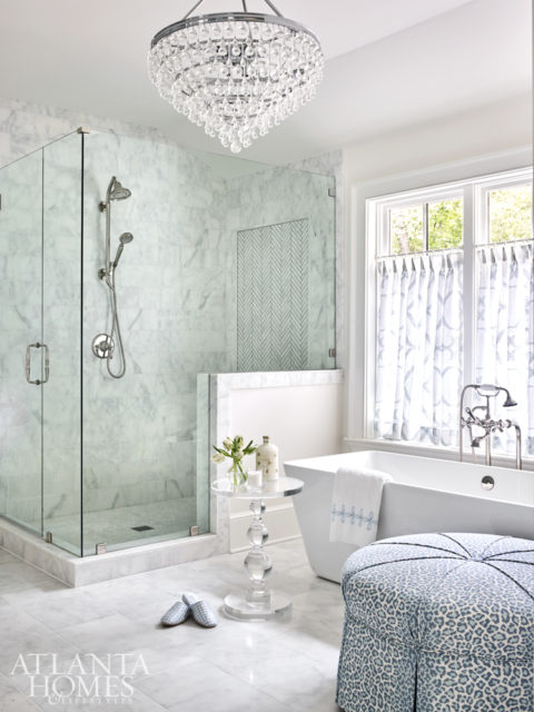 An ottoman from Wesley Hall covered in a blue-and-white leopard print from Cowtan & Tout adds a touch of softness to the master bathroom. The tub is by Victoria & Albert from Ferguson.