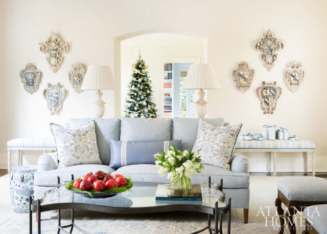 A Newman Frey coffee table strikes a curvy note while alabaster lamps from Joseph Konrad top the sofa table. Hand-painted Italian crests from Foxglove Antiques & Galleries adorn the walls. The benches are upholstered in a Jasper fabric through Ainsworth-Noah.