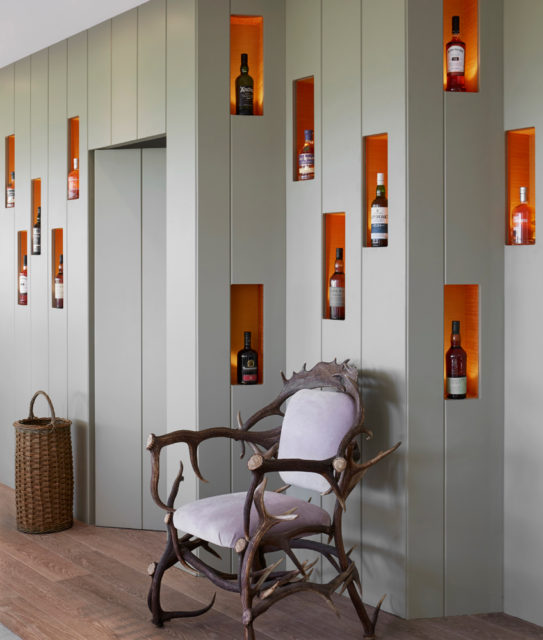 Locally sourced furniture and whiskies sit comfortably in a rustic corner.