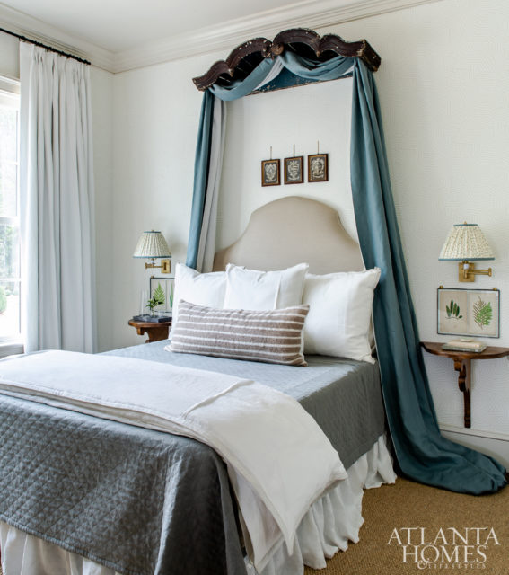 In the guest bedroom, the top of a vintage armoire serves as the bed crown. Other unique accents include framed Italian family crests displayed just above the headboard. To keep things fresh, Schumacher’s Deconstructed Stripe wallcovering adds a touch of modern.
