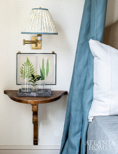 Antique demilune nightstands mounted on the wall add a historic edge to a guest bedroom.