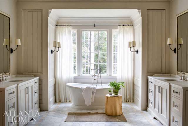 The master suite’s serene, pared-down palette continues into the bath. Additional storage is hidden in the walls adjacent to the vanities.