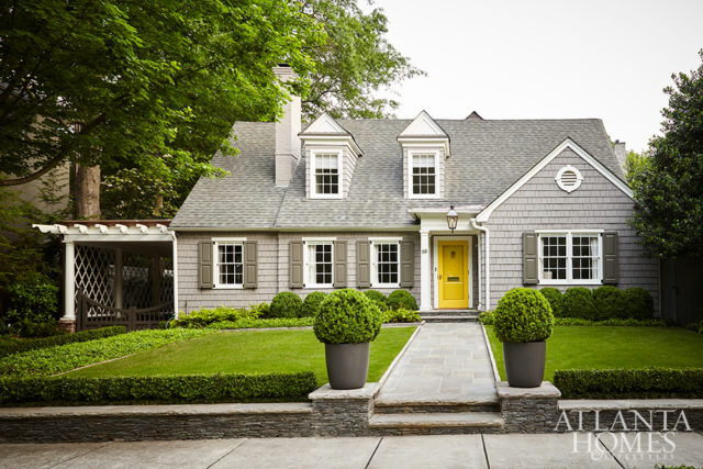 American boxwoods line the newly manicured front lawn. The fiber cement planters are by Greenform.
