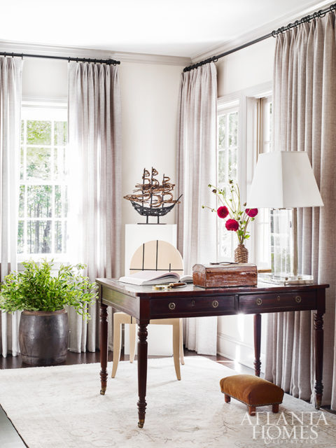An office nook showcases the home’s traditional-meets-modern design ethos. J. Robert Scott’s Geo chair enlivens the 19th-century writing desk from Parc Monceau. The ship sculpture is by famed Irish artist John Behan.