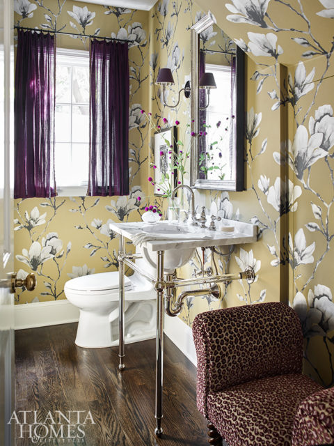 The bold, but airy patterned Harlequin wallpaper refrains from overwhelming the powder room.