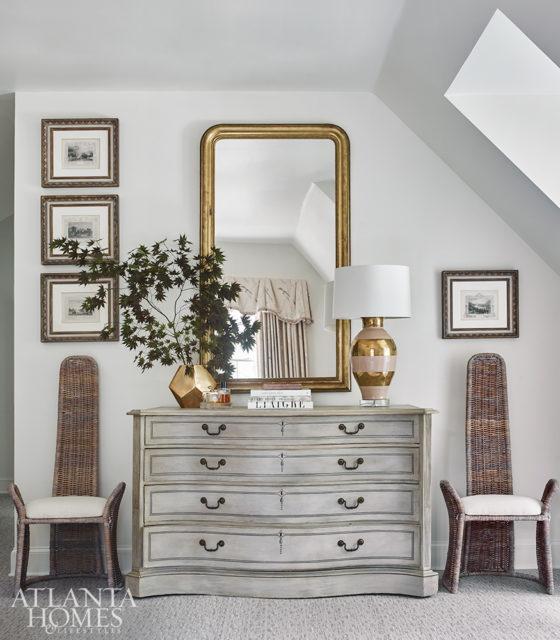 right To contrast the master suite’s ladylike design, a quirky pair of vintage chairs from Interiors Market flanks a gray antique chest. Burgess balanced the room’s sloping rooflines with a creative arrangement of the client’s art collection.