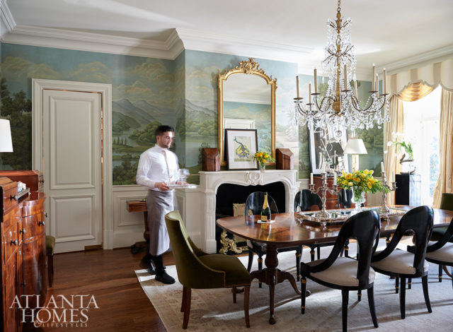 In the dining room, a chandelier from Ainsworth-Noah makes a statement above a dining table from Parc Monceau. The chairs are from Parc Monceau and Hickory Chair.
