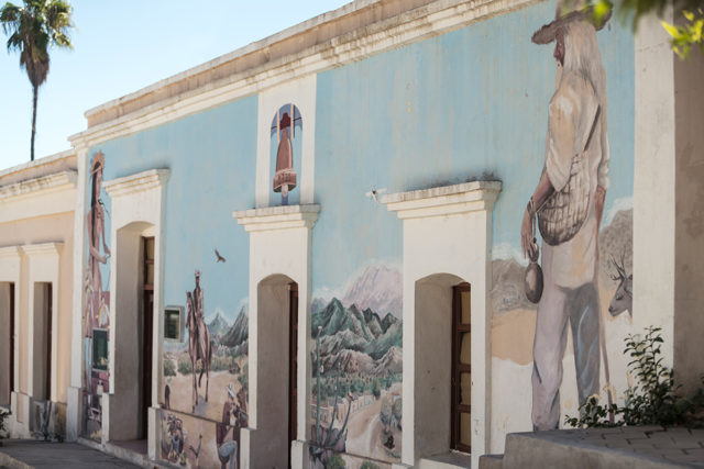 Colorful murals splash the sides of several resort buildings.