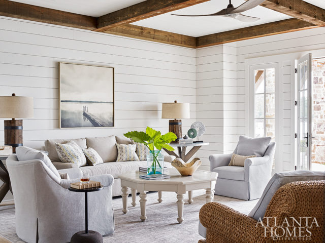 A fine art photograph from Stanton Home Furnishings brings the outside into the first-floor family room, a neutral milieu accented with colorful pillows covered in fabric by Jim Thompson.