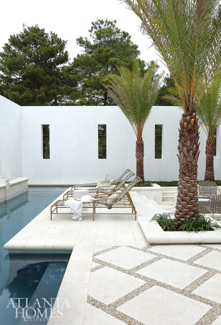 Brass sling chaise lounges and chairs add a subtle touch of glamour to the pool.
