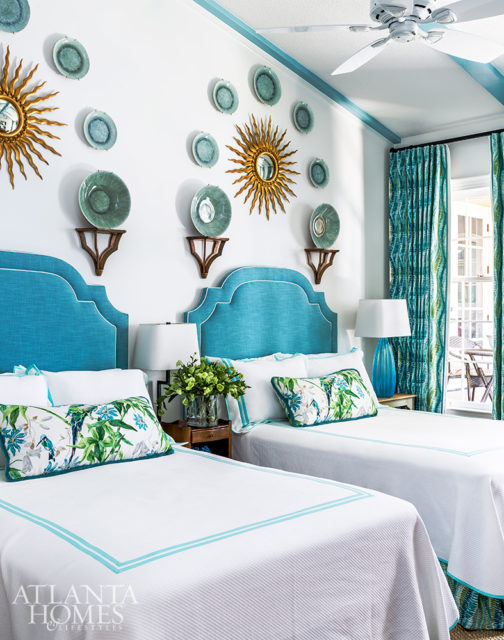 Coastal colors abound in the guest bedroom where an array of kelp-green plates floats above custom turquoise headboards.