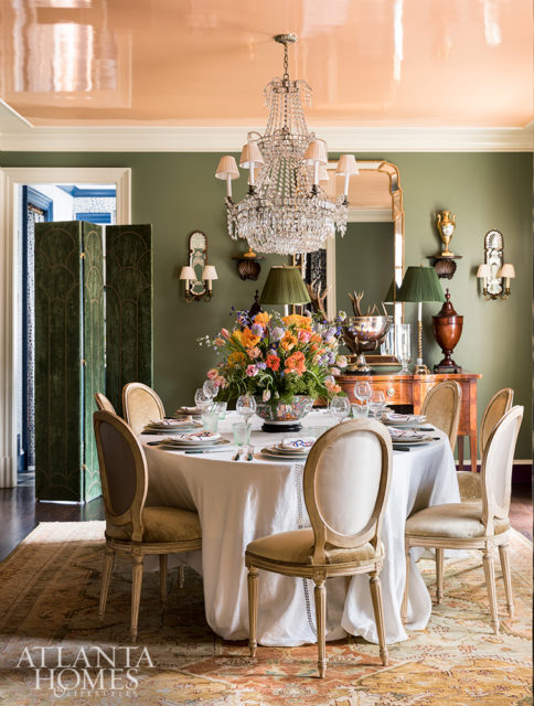 Lacquered cantaloupe ceilings cast a flattering glow. “At the end of the day, creating atmosphere is what it’s all about,” says Rollins of entertaining at home. A stylish dinner party should put you “in the moment, and make you feel as if there’s nowhere else in the world you’d rather be.” Photo by Lesley Unruh/One Kings Lane