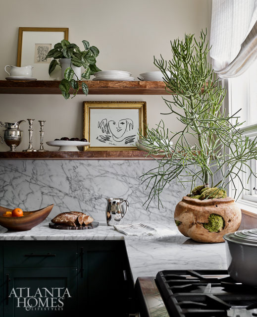 Wood shelving with a live edge adds a sense of rusticity to the more tailored finishes in the bright and airy kitchen.