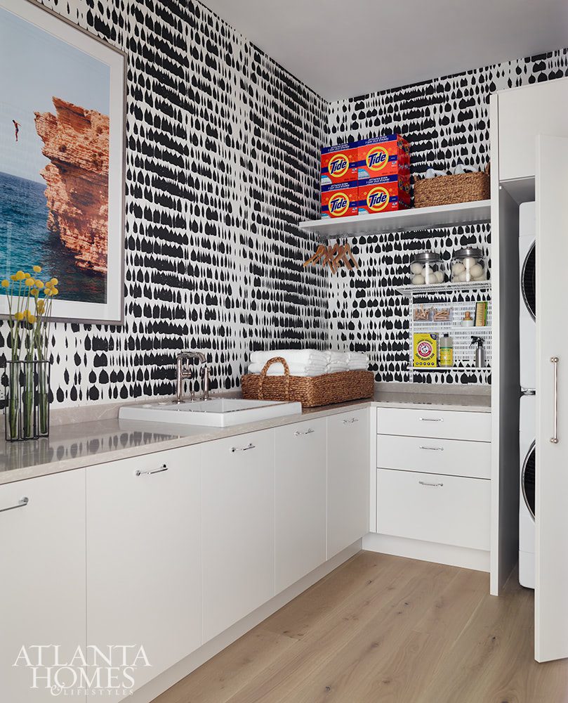 laundry room with graphic wallpaper