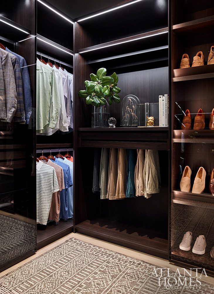 his closet with custom dark wood cabinets