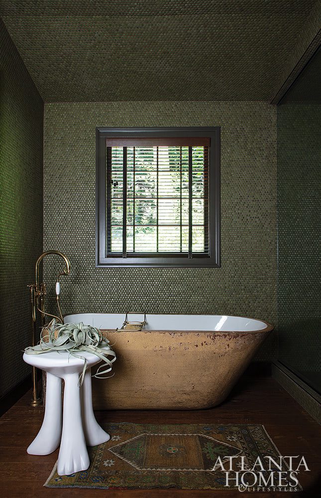 green penny tile bathroom with stone clay tub