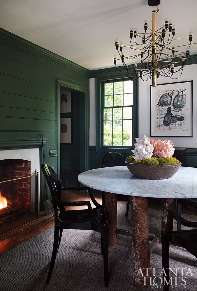 green dining room with fireplace