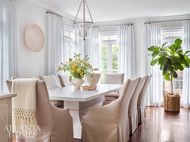 white dining room with glass chandelier