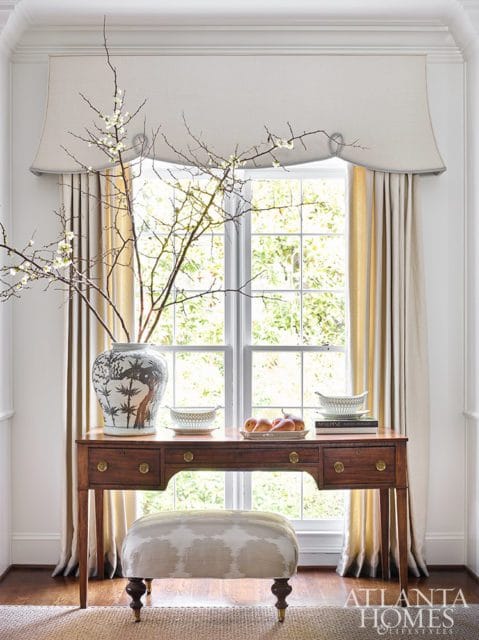 formal drapery over a writing desk