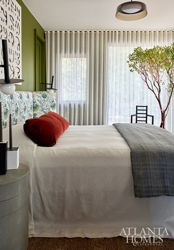 green bedroom with white bed