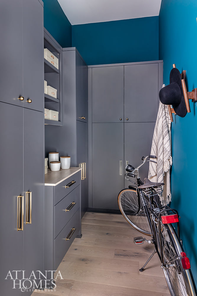 teal mudroom with gray cabinets