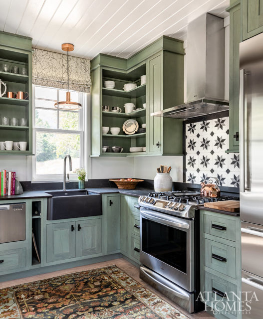 green kitchen cabinets with tile backsplash and open shelves