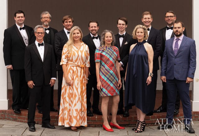 Group of people in formal wear posing outdoors, with Atlanta Homes & Lifestyles logo in the corner.