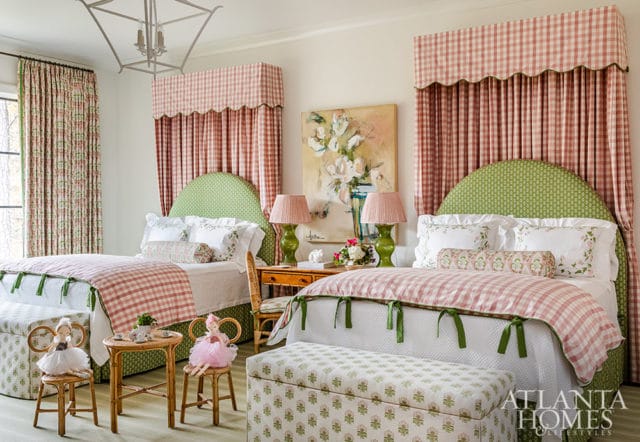 Bedroom with two beds, green headboards, pink gingham bedding, and floral curtains.