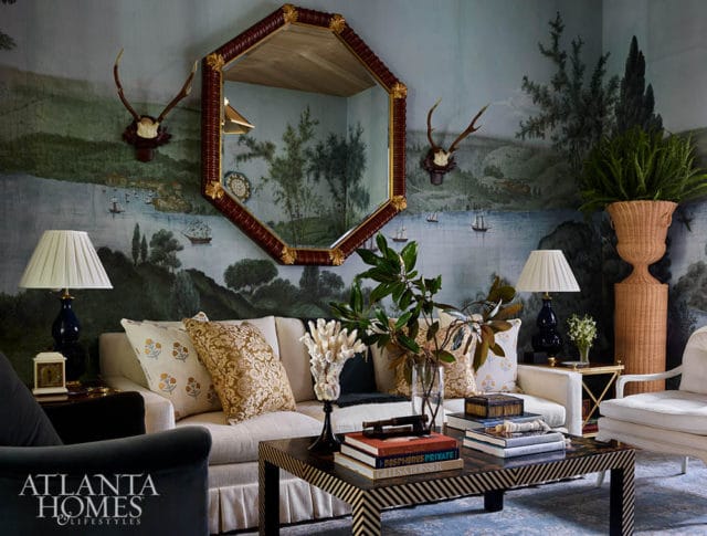 Living room with mural wallpaper, hexagonal mirror, sofa, and coffee table