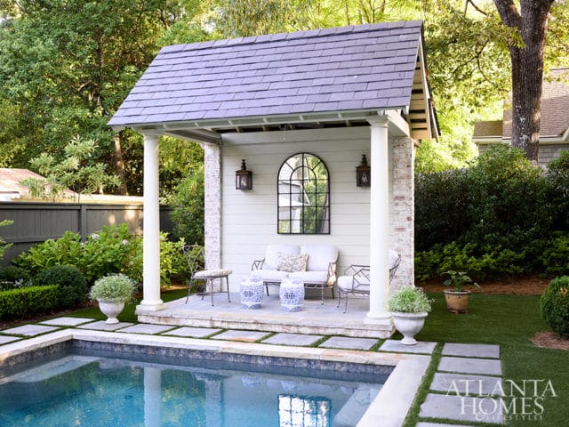 Poolside pavilion with seating, arched mirror, and brick accents.