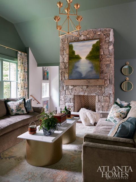 Living room with green ceiling, stone fireplace, and plush seating. Atlanta Homes logo visible.