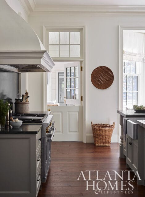 Gray kitchen with dark countertops, stainless steel range, and Dutch door.