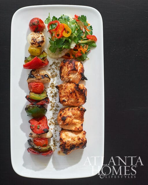 Grilled chicken skewers with grilled vegetables and salad, Atlanta Homes & Lifestyles logo