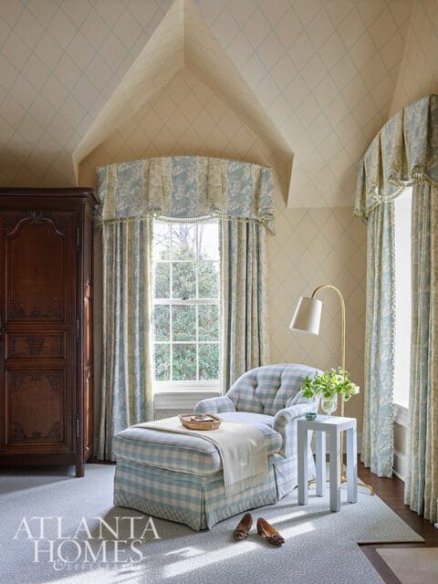 Light blue gingham chaise lounge with white throw blanket and a small white side table.