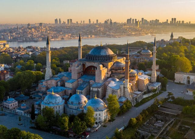 Hagia Sophia mosque at sunrise with Istanbul skyline in the background