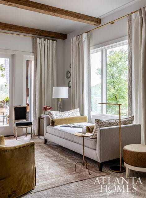 Living room with light gray chaise, gold bolster pillow, and patterned accent pillows.