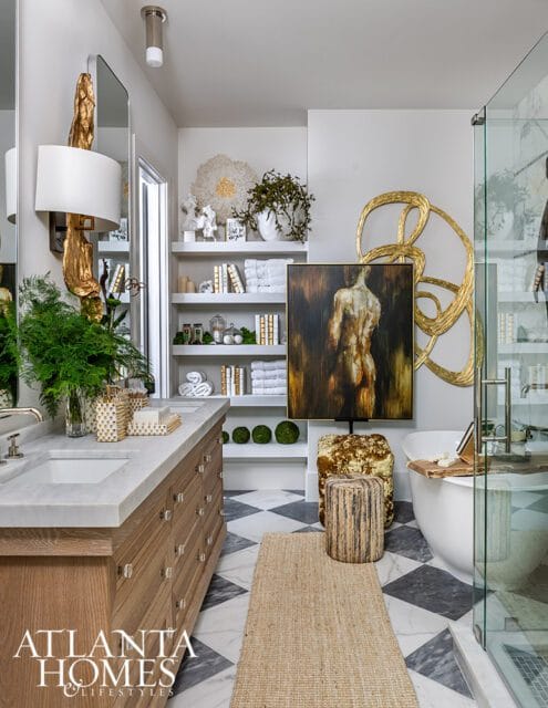 Bathroom with marble vanity, checkered floor, artwork, and freestanding tub.