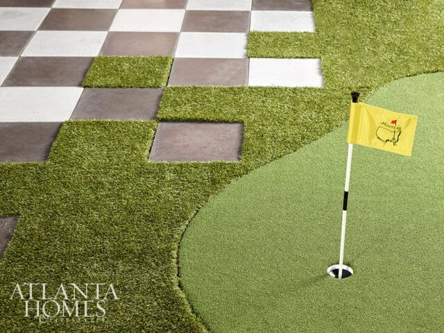 Yellow Masters flag on putting green next to checkered patio