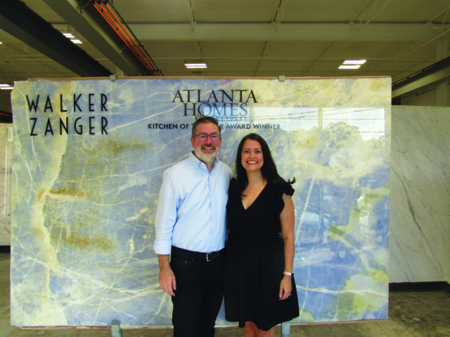 Man and woman in front of blue marble slab with Walker Zanger and Atlanta Homes logos