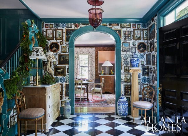 Entryway with black and white checkered floor, gallery wall, and arched doorway to dining room.