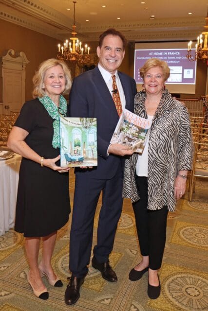Three people holding books, one titled "At Home in France" and another "Atlanta Homes"