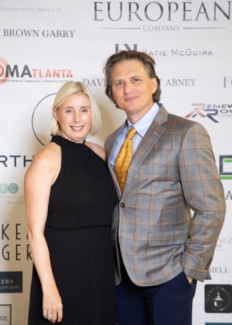 Woman in black dress and man in plaid suit with yellow tie